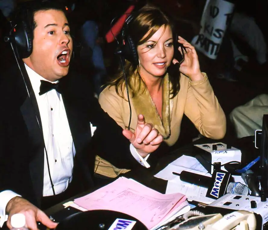 Ms. Buss, ringside at a taping of WOW with David McLane, who founded the league.Credit…WOW Television Enterprises, LLC