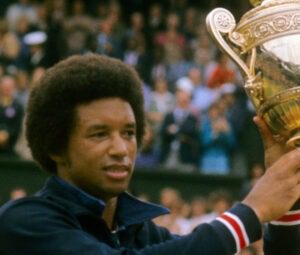 Arthur Ashe holding a trophy