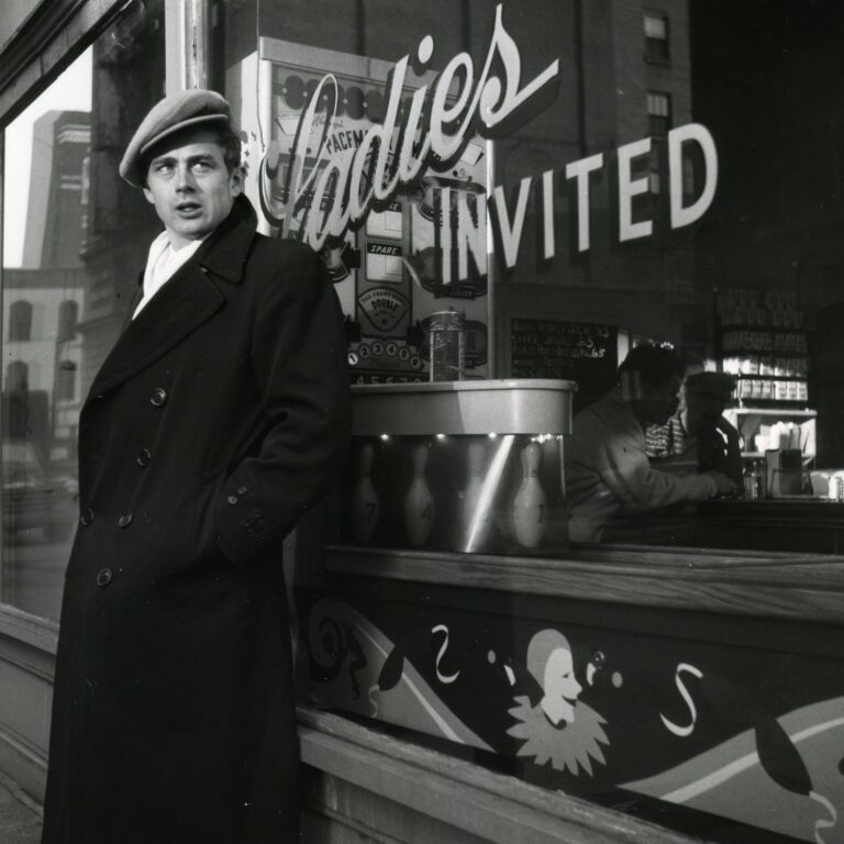 James Dean standing against a window