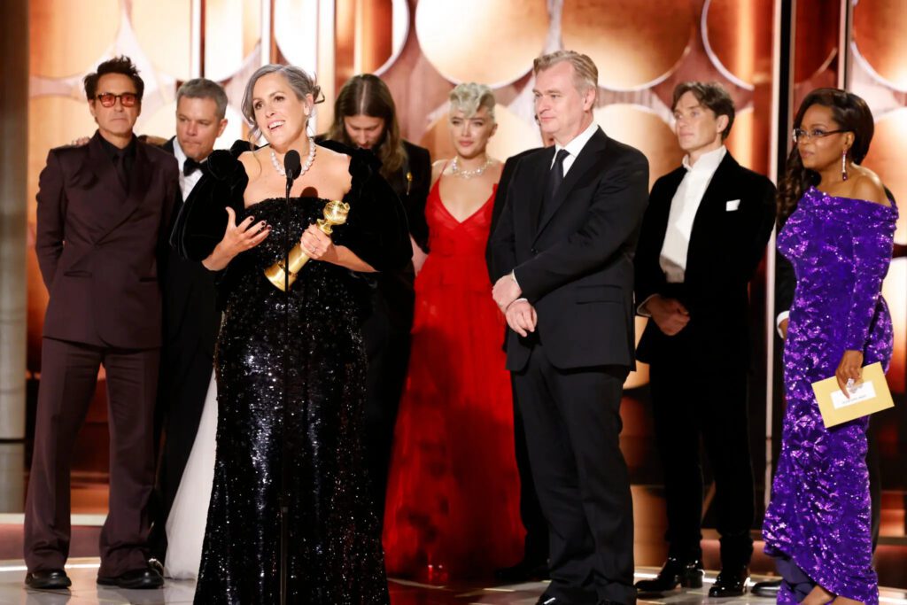 The producer Emma Thomas, front left, with the director Christopher Nolan, right, accepting the best drama award for “Oppenheimer.”Credit...Sonja Flemming/CBS Entertainment, via Associated Press